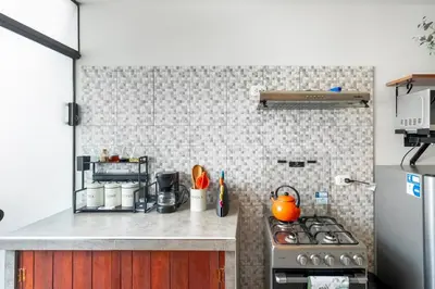 a kitchen with a stove and a refrigerator at Equipped Loft with Sofa Bed and Balcony in Lima