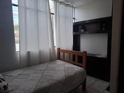 a small bedroom with a bed and a window at Lindo Atardecer in Ica