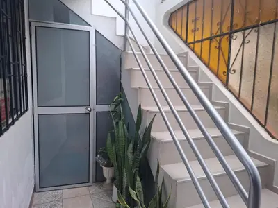 a staircase with a door and a plant at Lindo Atardecer in Ica