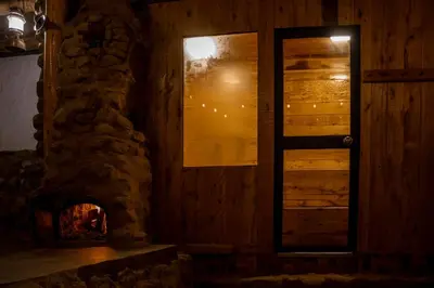 a room with a fireplace and a window at Unu Samay Lodge in Urubamba
