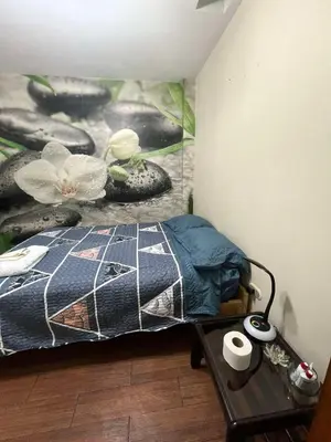 a bedroom with a bed and a table with towels at Las palmeras in Lima