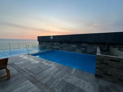 a swimming pool on the side of a building at Oceanfront apartment, Pool, Gym, Sauna, Arcade in Lima
