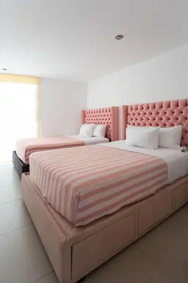 two beds sitting next to each other in a bedroom at Sarapampa punto Asia in Asia