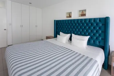 a bedroom with a large bed with a blue headboard at Sarapampa punto Asia in Asia
