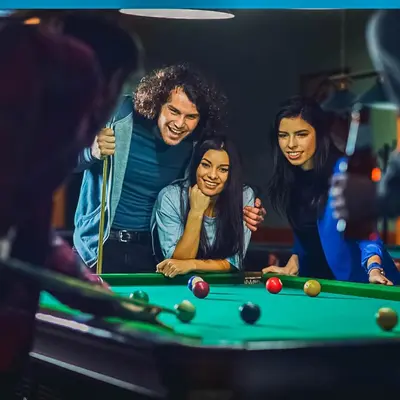 a group of people standing around a pool table at Sarapampa punto Asia in Asia
