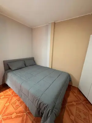 a small bedroom with a bed in the corner at Central and brand new apartment in Huamanga in Ayacucho