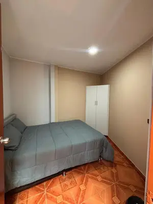 a bedroom with a bed and a white cabinet at Central and brand new apartment in Huamanga in Ayacucho