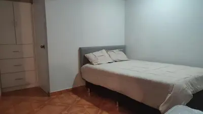 a small bedroom with a bed and a closet at Central and brand new apartment in Huamanga in Ayacucho