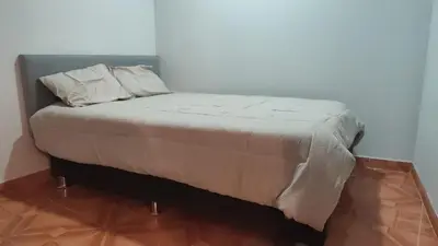 a bed with two pillows on it in a room at Central and brand new apartment in Huamanga in Ayacucho