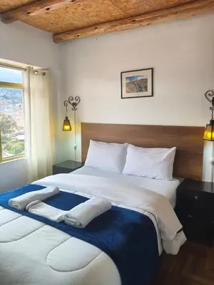 a bedroom with two beds with towels on them at Imperial City Apartment in Cusco