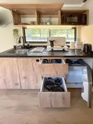 a kitchen with a sink and a counter top at Tiny Mountain River in Urubamba