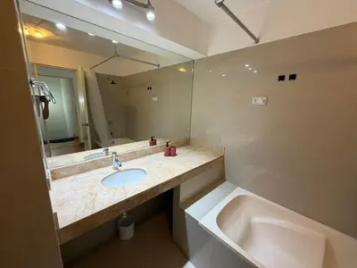 a bathroom with a sink and a tub and a mirror at Duplex en Miraflores av larco 1010 in Lima