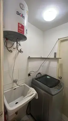 a bathroom with a sink and a washing machine at Duplex en Miraflores av larco 1010 in Lima