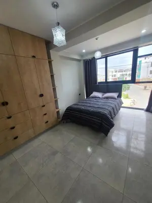 a bedroom with a bed and a large window at Departamento en ica de estreno in Ica