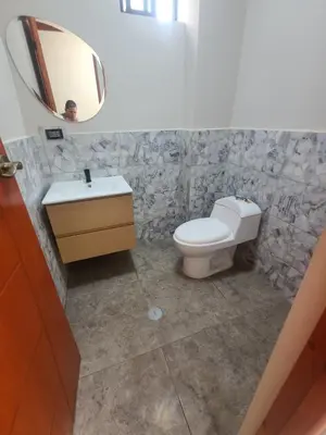 a bathroom with a toilet and a sink and a mirror at Departamento en ica de estreno in Ica