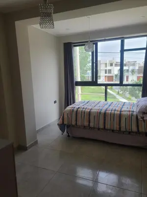 a bedroom with a bed and a large window at Departamento en ica de estreno in Ica