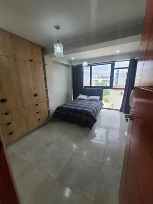 a bedroom with a bed and a large window at Departamento en ica de estreno in Ica