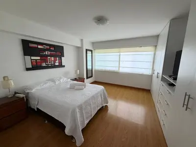 a bedroom with a bed and a television in it at Apartamento con ascensor en segundo piso, Miraflores in Lima