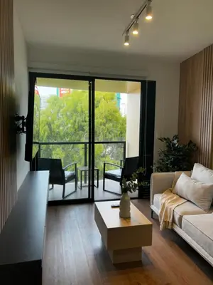 a living room with a couch and a table at Loft Bohemio a 1 cuadra de plaza Barranco in Lima