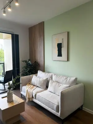 a living room with a couch and a table at Loft Bohemio a 1 cuadra de plaza Barranco in Lima