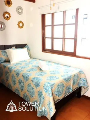 a bedroom with a bed and a window at Casa Cayena in Lima