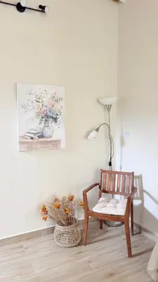 a room with a wooden chair and a painting on the wall at Casa San José - Bungalow 5 in Ica