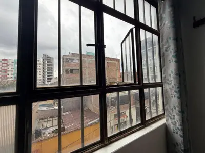 a window with a view of a train yard at Hospedaje Tarapacá in Huancayo