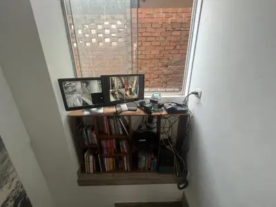 a book shelf with two pictures and a window at Ministery The Bleasing in Lima
