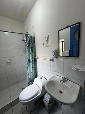 a bathroom with a sink and a toilet and a mirror at Posada Bayoneta in Cusco