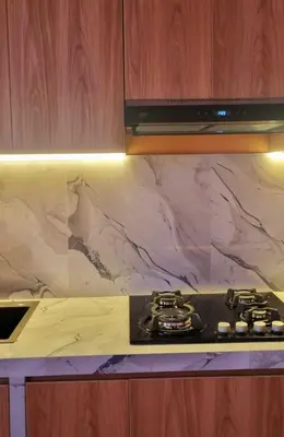 a stove top in a kitchen with a marble counter top at Cusco Apartment Prime Location in Cusco