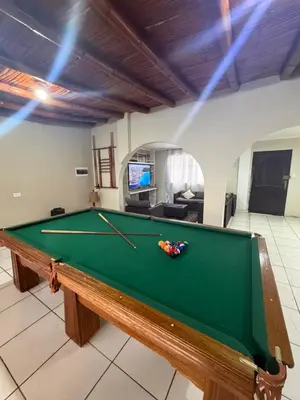 a pool table in the middle of a living room at Casa de playa in Arica
