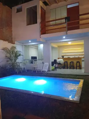 a swimming pool in front of a house at Excellent house in Quilmana in Quilmaná