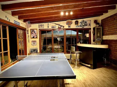 a ping pong table in the middle of a room at Casa de Campo Quives Majestuoso 5BR in Santa Rosa de Quives