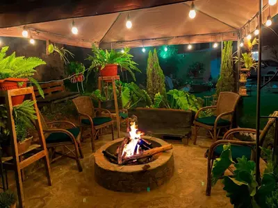 a fire pit in a patio with chairs and plants at Casa de Campo Quives Majestuoso 5BR in Santa Rosa de Quives