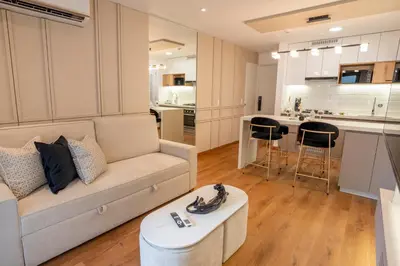 a living room with a couch and a kitchen at Miraflores Prime Apartment - full AC-Kennedy Park in Lima