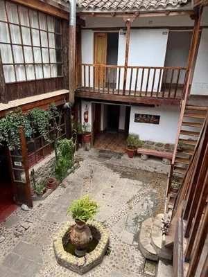 a courtyard of a house with a potted plant at plaza inn in Ollantaytambo