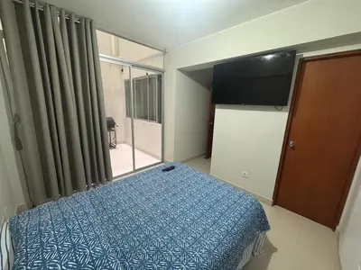 a bedroom with a bed and a large window at Apartment in San Bartolo - Playa Norte in San Bartolo
