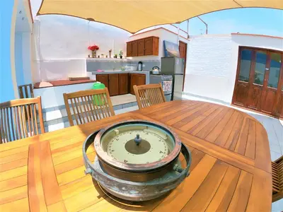 a table with a bowl on top of a wooden table at Waves Surf Camp Peru in Punta Hermosa