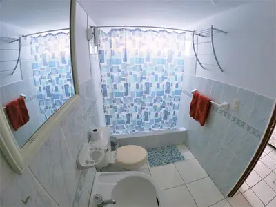 a bathroom with a toilet and a shower at Waves Surf Camp Peru in Punta Hermosa