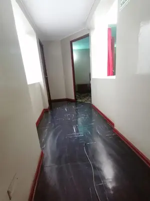 an empty room with a black floor and a door at Kenko in Lima