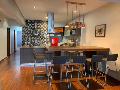 a kitchen with a table and chairs in a room at Larcomar Luxury Penthouse in Lima