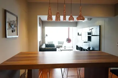 a kitchen and living room with a wooden table at Larcomar Luxury Penthouse in Lima
