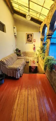 a room with two beds and a wooden floor at Hostel Imperial BACKPACKER in Cusco