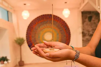 a person holding a small bowl in their hands at Supertramp Hostel Cusco in Cusco