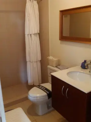 a bathroom with a toilet and a sink and a mirror at Lima Flats 2 in Lima