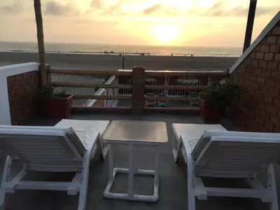 a patio with a table and chairs and the beach at Bujama Campo Mar in Bujama Baja