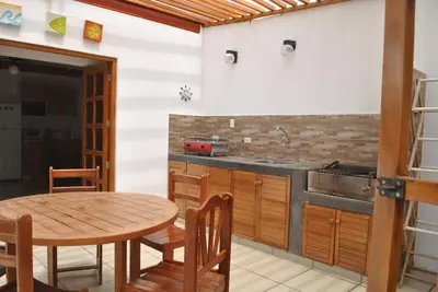 a kitchen with a table and a sink and a table and chairs at Bujama Campo Mar in Bujama Baja