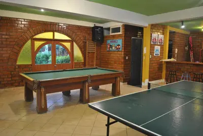 a room with a ping pong table in it at Bujama Campo Mar in Bujama Baja