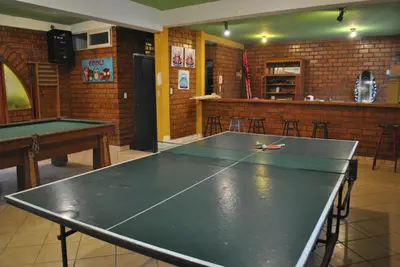 a ping pong table in a room with a ping pong ball at Bujama Campo Mar in Bujama Baja