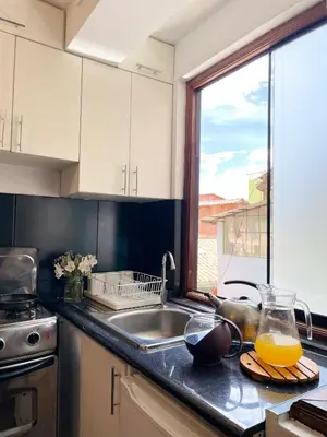 a kitchen with a sink and a window at Allincay Cusco Apart Hotel in Cusco